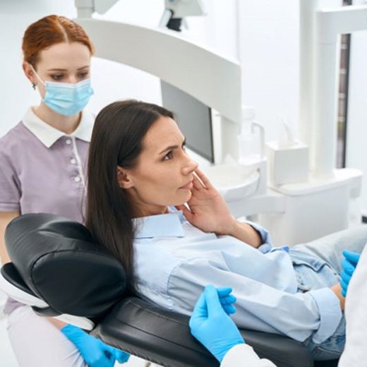 Concerned patient talking to dental team